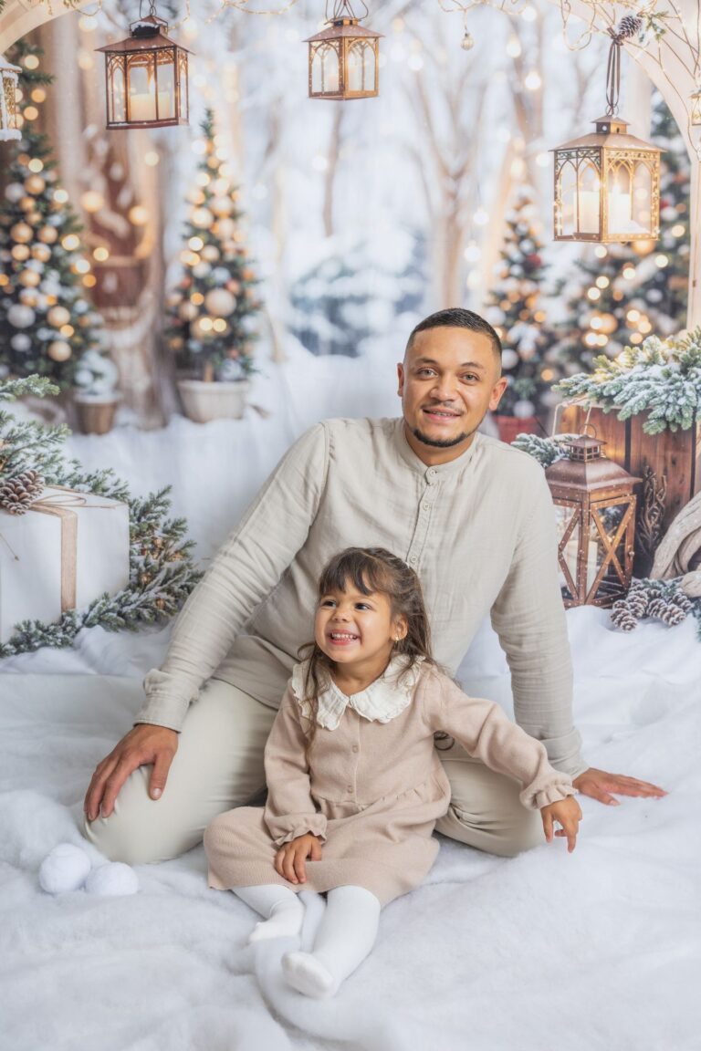 Père et fille dans décor de Noël enneigé